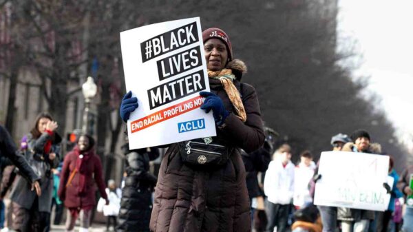 woman holding a Black Lives Matter Sign
