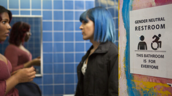 Two students in a gender neutral bathroom - LGBTQIA Rights Image