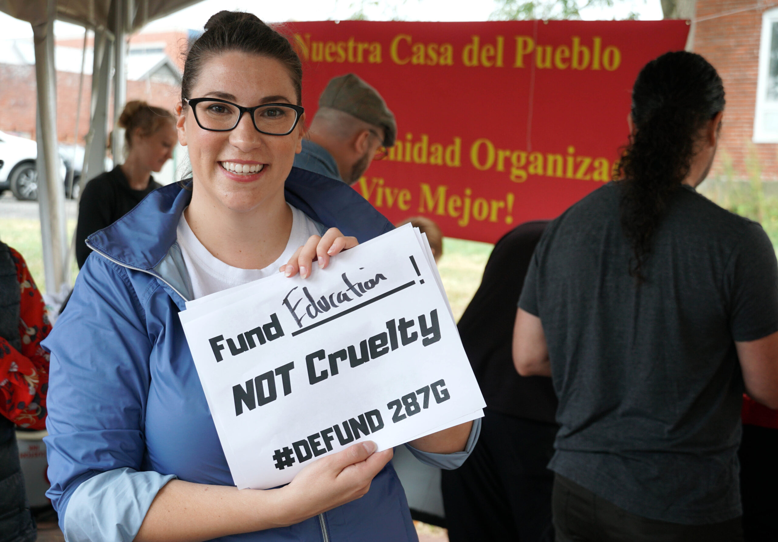 RISE Coalition of Western Maryland member Juliana Downey holds sign saying