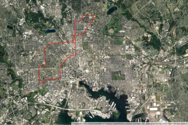 Aerial view of Baltimore with red line drawn around area under mass surveillance.