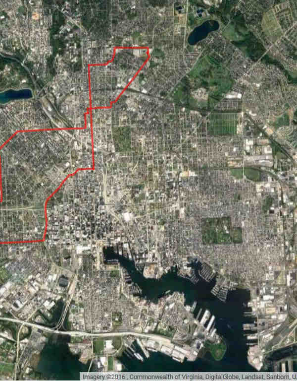 Aerial view of Baltimore with red line drawn around area under mass surveillance.