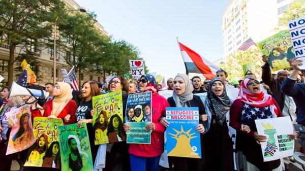 Group of protestors marching with signs supporting Muslim people after Trump's Muslim Ban executive order.
