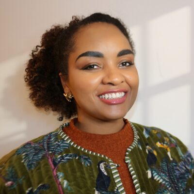 photo of Dara Johnson with curly hair and colorful shirt