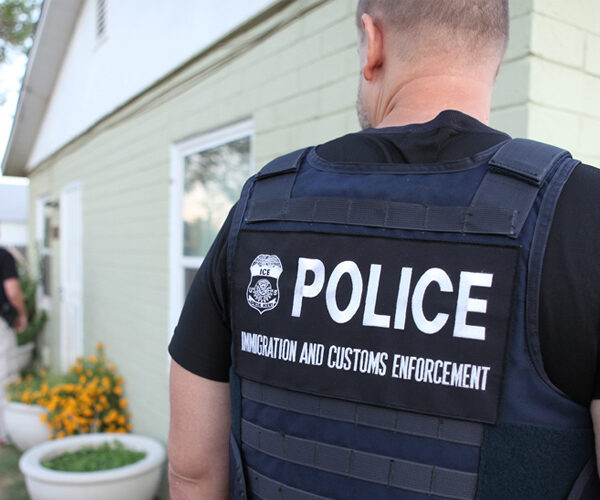 Several ICE officers are at a person's home.