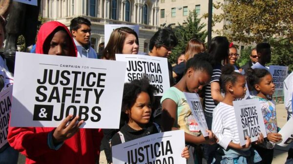 Campaign for Justice, Safety, and Jobs rally - people are at a protest holding signs