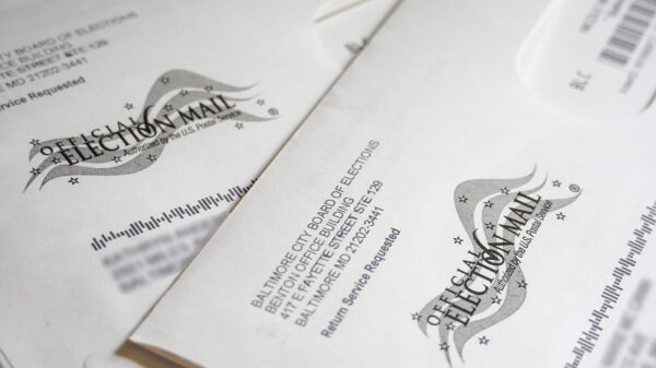 There are two mail letters that say official election mail, with the names and addresses blurred out.