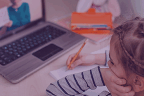 Child distance learning in front of a laptop.