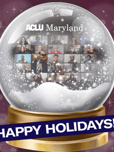 Image shows a snow gloge with ACLU of Maryland staff shown in a grid in a Zoom meeting. The bottom says Happy Holidays on a navy blue background slightly angled. The background of the image is a dark fuschia with sparkles.