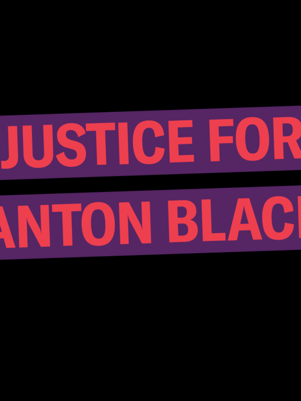 Justice for Anton Black. The background is black, the words are red in a purple rectangle that is slightly tilted up.