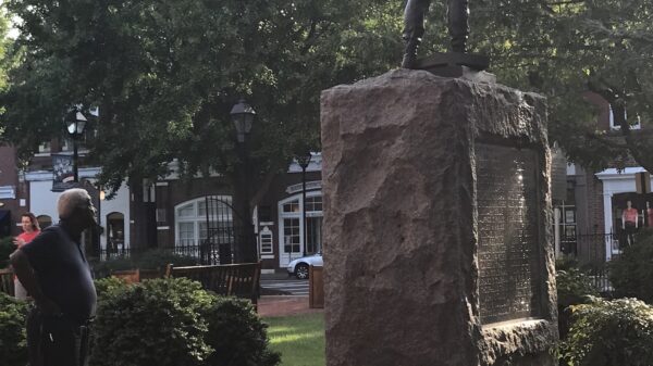 A Black man looks at the Talbot County Confederate statue in Easton, Maryland.