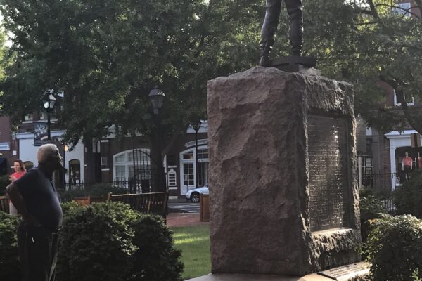 A Black man looks at the Talbot County Confederate statue in Easton, Maryland.