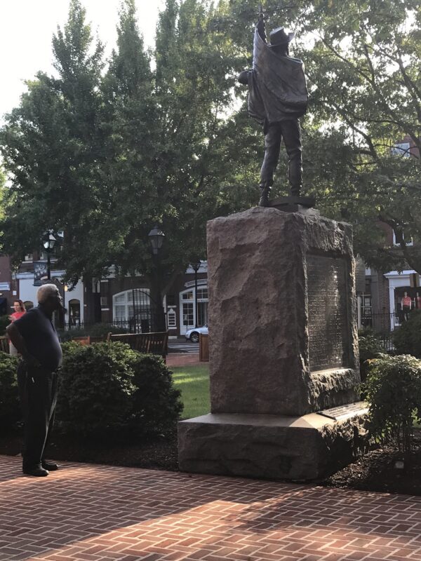 A Black man looks at the Talbot County Confederate statue in Easton, Maryland.