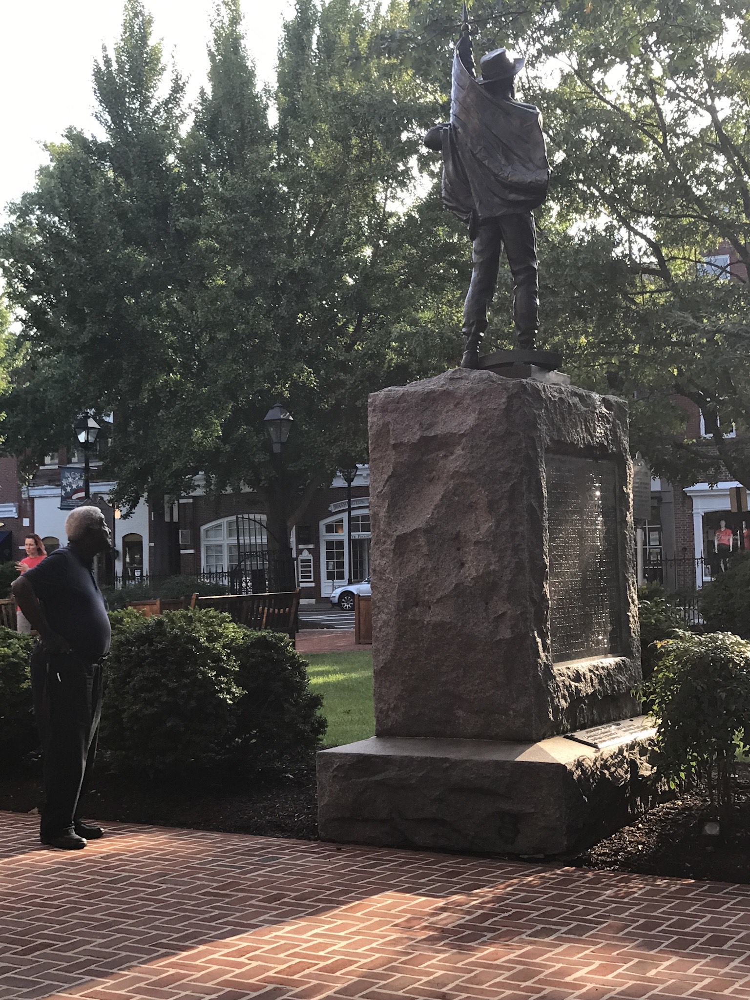 A Black man looks at the Talbot County Confederate statue in Easton, Maryland.