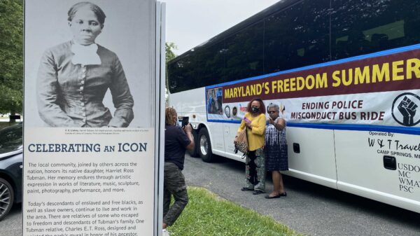 Maryland's Freedom Summer bus beside a sign celebrating the icon Harriet Tubman.
