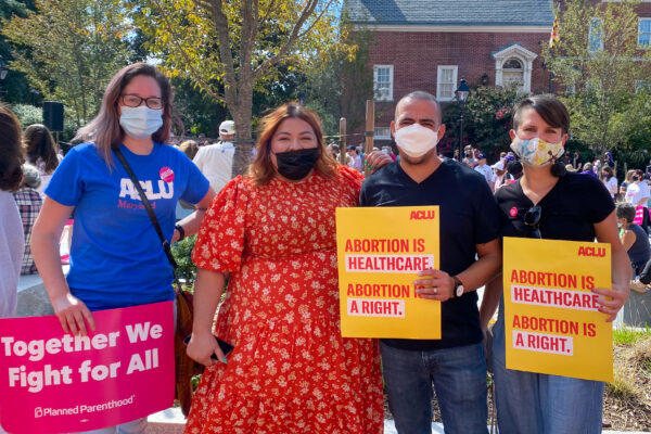 Ellen Hutton, Lorena Diaz, Sergio España, and Amy Cruice hold abortion rights protest signs at a rally in Annapolis to defend abortion.