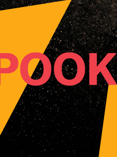 Image says "Spooky!" Background is balck with white specks. Dark yellow triangles are on the right and left sides.