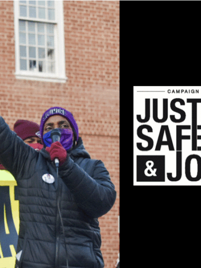 A black person with their fist raised at a rally is speaking into a mic and the Campaign for Justice, Safety, and Jobs CJSJ logo is on the right over a black background.