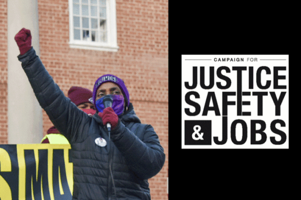 A black person with their fist raised at a rally is speaking into a mic and the Campaign for Justice, Safety, and Jobs CJSJ logo is on the right over a black background.