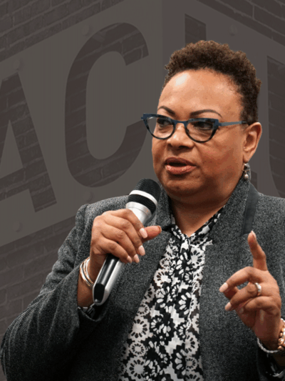 Dana Vickers Shelley is in the foreground and a picture of the ACLU sign and brick wall is in the background with a dark gray brown overlay.