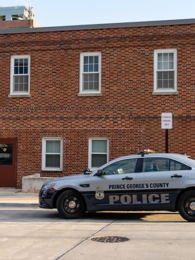 Prince George's County police cruiser in front of a brick building