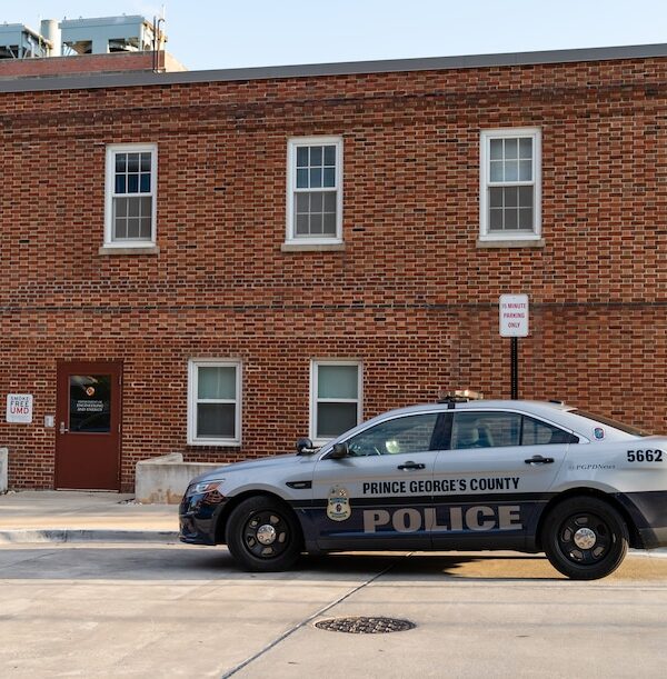 Prince George's County police cruiser in front of a brick building