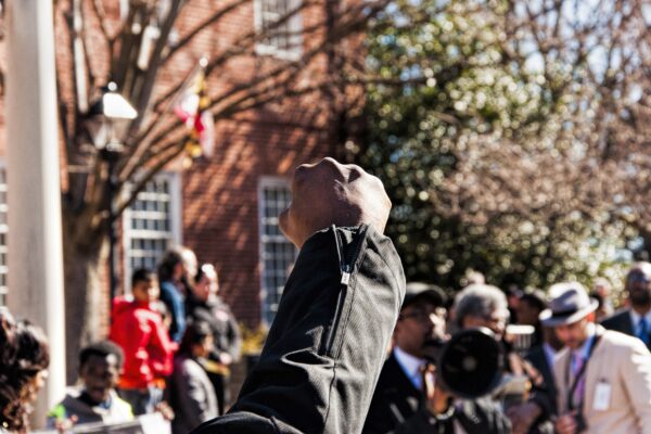 Black person's raised fist at a protest in Maryland.
