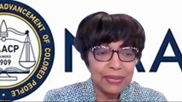 Dr. Willie Woods is a Black woman with medium brown skin. She has short dark hair, is wearing glasses, and is in front of a virtual background with part of the NAACP logo visible behind her.