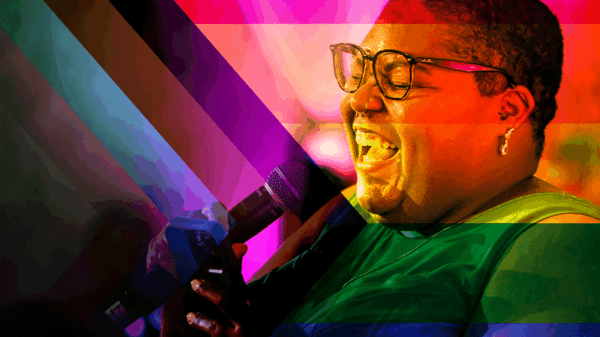 Picture of Alicia Smith signing into a microphone. The image is filtered on a progress pride flag and the colors are all blended.
