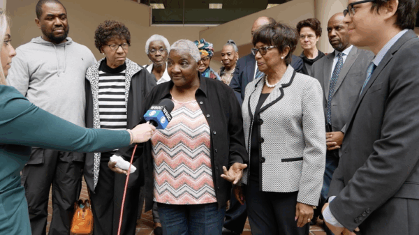 Local Black activists, residents, and Maryland laywers are in a group outside of a Federalsburg courthouse with a reporter holding a microphone up to a Black resident.