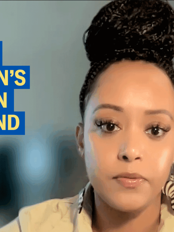 Protect children's rights in Maryland. Yanet Amanuel is pictured on the right of the image with a blurred background. She is a Black woman with latte skin town. Her hair is pulled up in a bun of small braids. She is wearing eaarings and a creamy top.