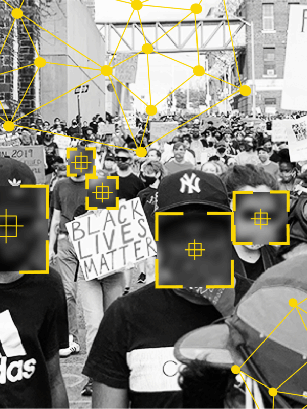 Black and white photo of people at a protest. There are overlays over people's faces that signify facial recognition technology identifying people.