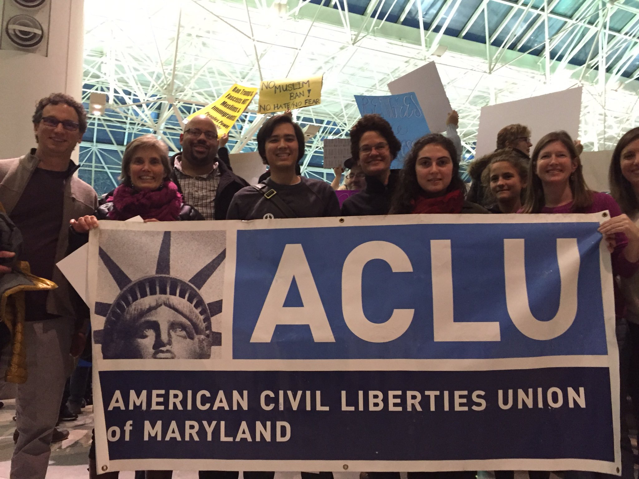 Group photo of ACLU of Maryland staff at BWI airport to support Muslim people arriving who were impacted by Trump's Muslim ban.
