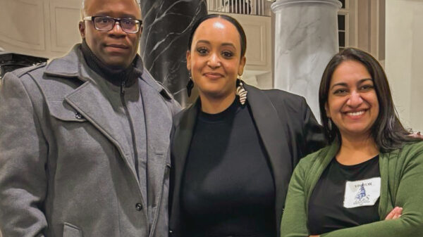 Anthony Muhammad, Yanet Amanuel, and Sonia Kumar stand together in the Maryland chamber houses on the day of a hearing in the House Judiciary Committee for the Maryland Second Look Act.