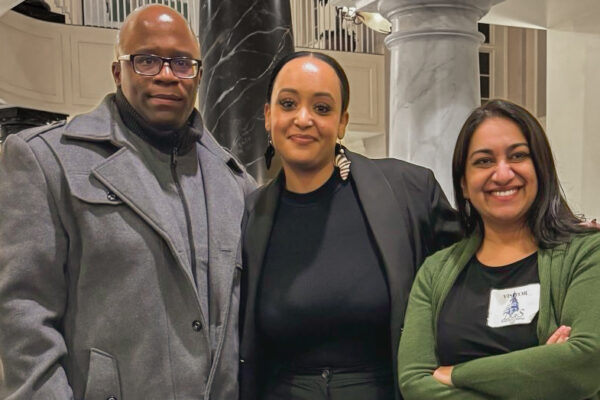 Anthony Muhammad, Yanet Amanuel, and Sonia Kumar stand together in the Maryland chamber houses on the day of a hearing in the House Judiciary Committee for the Maryland Second Look Act.