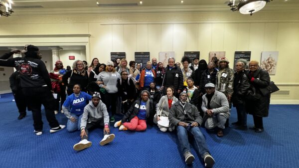 Group of advocates and directly impacted Marylanders take a group photo at in the legislative office building in Annapolis.