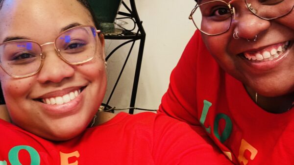 Antoinette and Alicia celebrating with family on Christmas 2023. They are wearing matching red holiday outfits.They were celebrating with family on Christmas 2023.