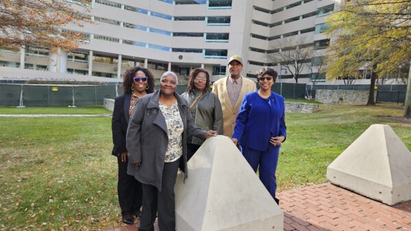 A group of Black residents and plaintiffs in the Federalsburg voting rights case stand together in front of a court building where their case was heard.
