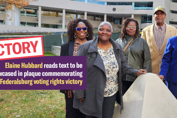 A group of Black residents and plaintiffs in the Federalsburg voting rights case stand together in front of a court building where their case was heard.