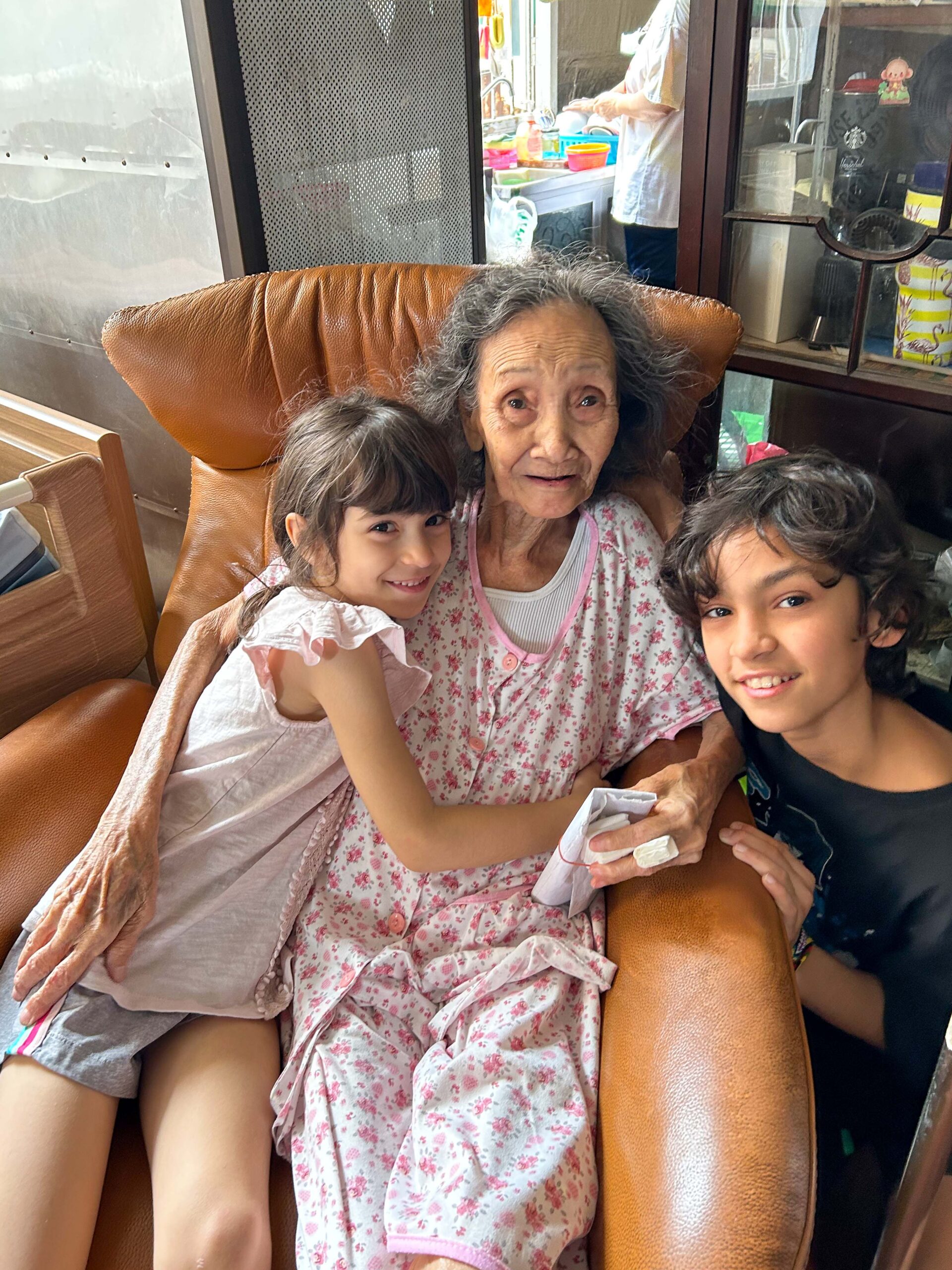 Frank's mom with his two children in Thailand.