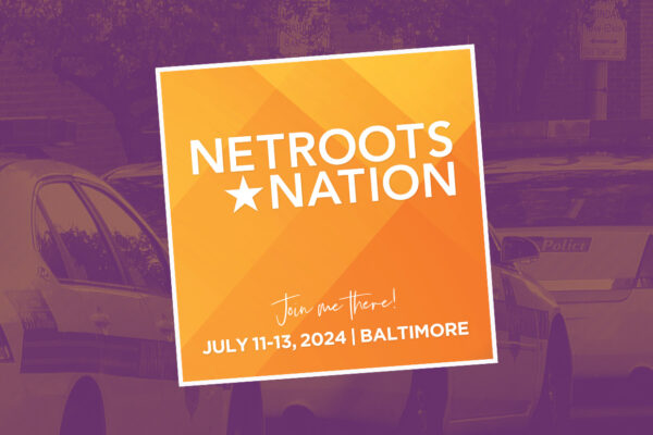 Netroots Nation conference logo. July 11, 2024 in Baltimore. Background has three parked Baltimore police cars.