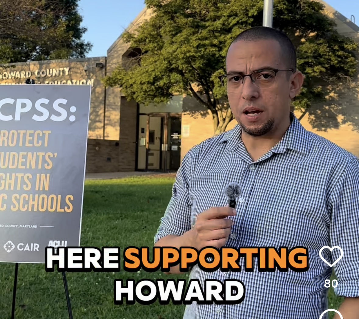 Sergio Espana is outside at an event in Howard County holding a small microphone.