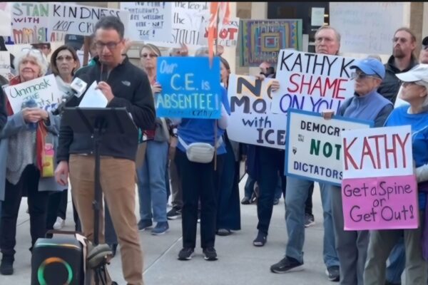 David giving a speech in front of community members at Towson Courthouse