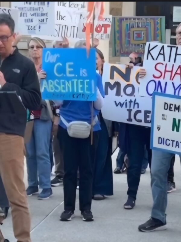 David giving a speech in front of community members at Towson Courthouse