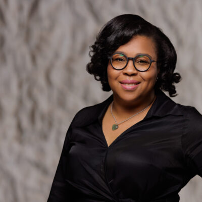 Stefany in a black shirt and black glasses