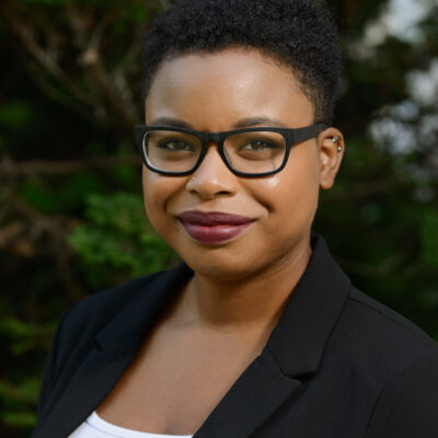 Tierra Bradford with dark glasses and blazer