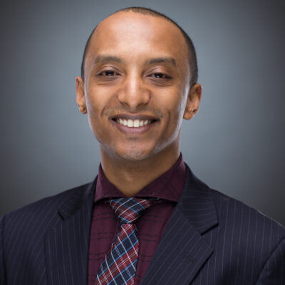 Hiruy in a dark suit and patterned tie
