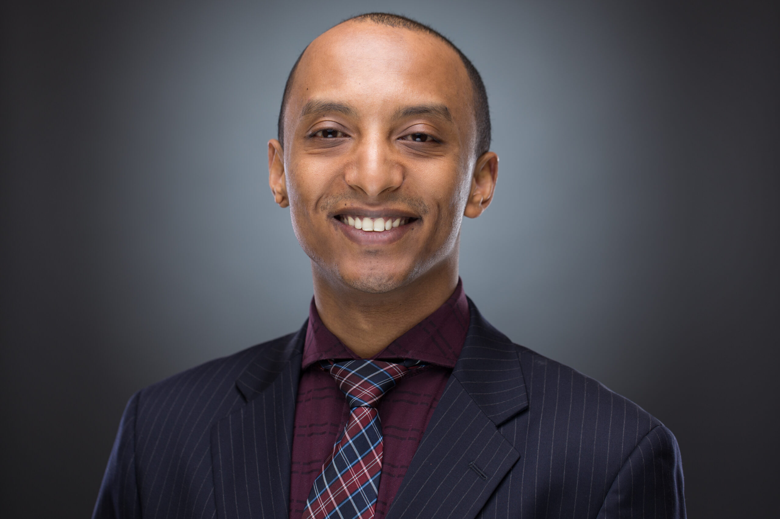Hiruy in a dark suit and patterned tie