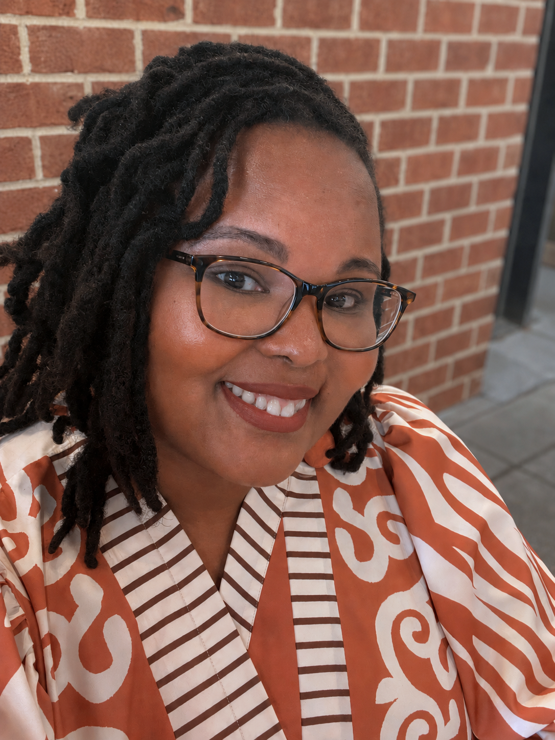 Ieshaah in dark rimmed glasses