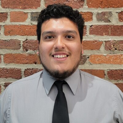 Jordy wears a black tie and gray shirt