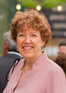Lynne seen smiling with a pink shirt